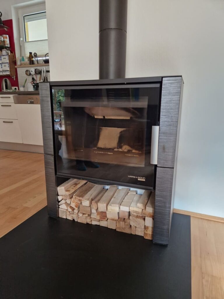 Moderner Heizkamin mit zusätzlicher Holzlagerung unter dem Ofen