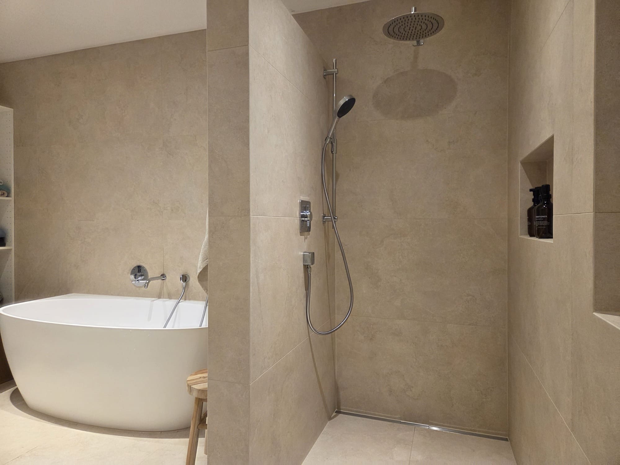 Saniertes Badezimmer mit bodengleicher Dusche und großformatigen Fliesen